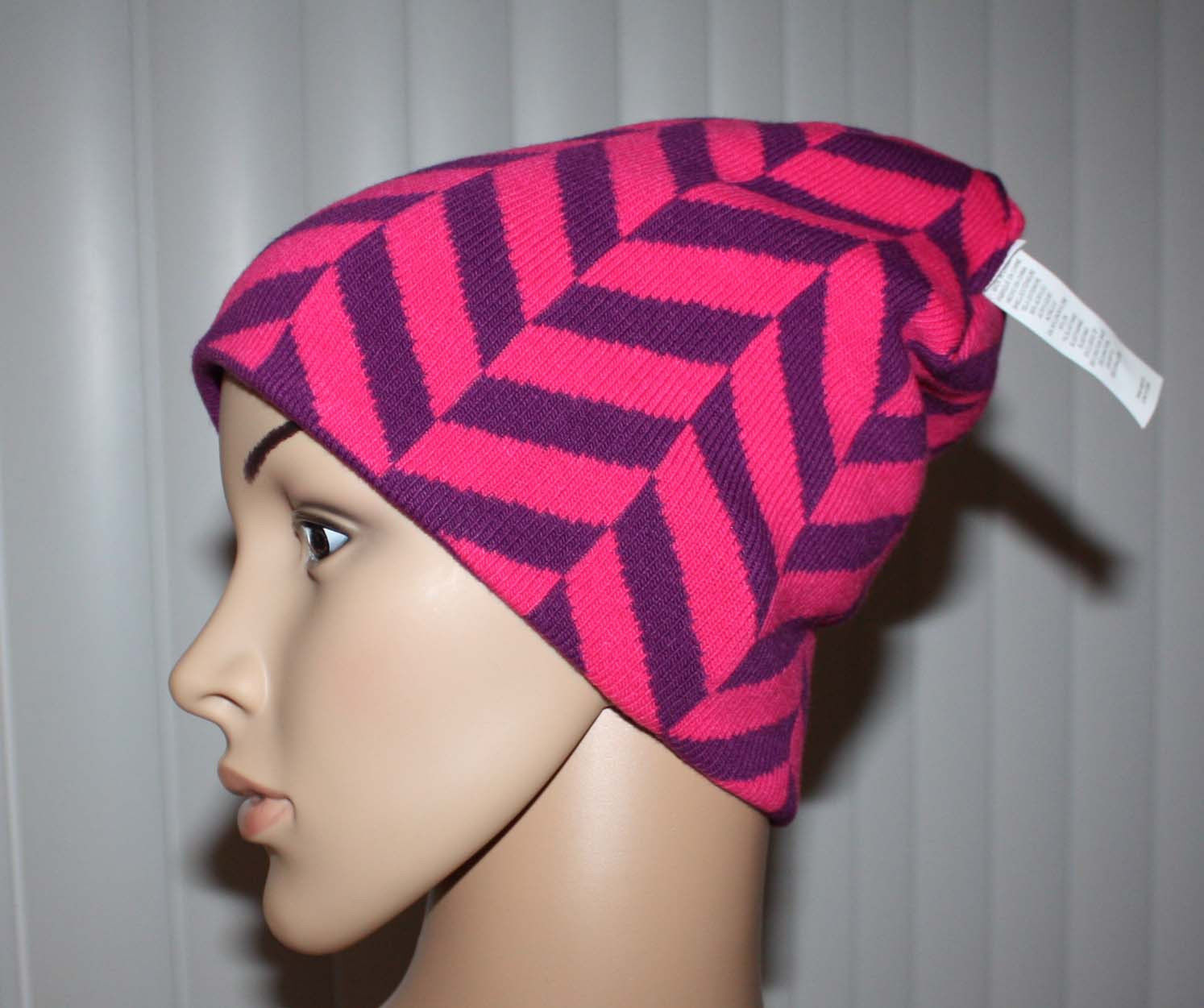 Reversible to a funky purple & pink print (side)