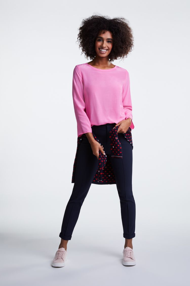 Bright pink top with 3/4 sleeves and dipped hem
