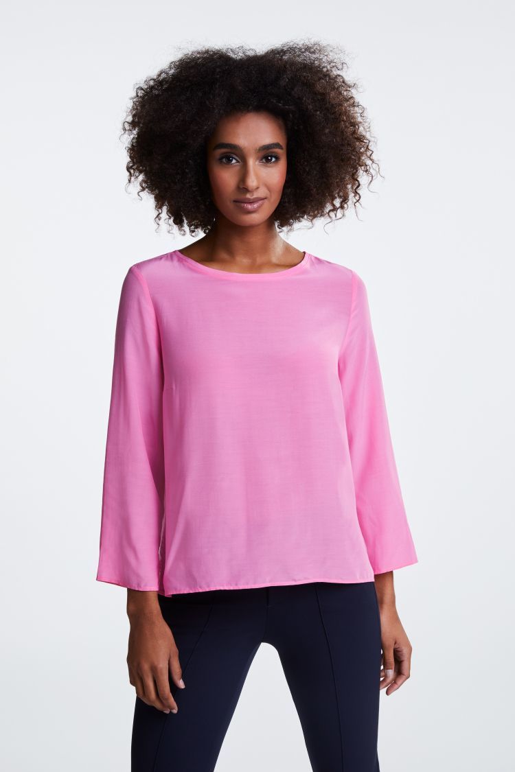 Bright pink top with 3/4 sleeves and dipped hem