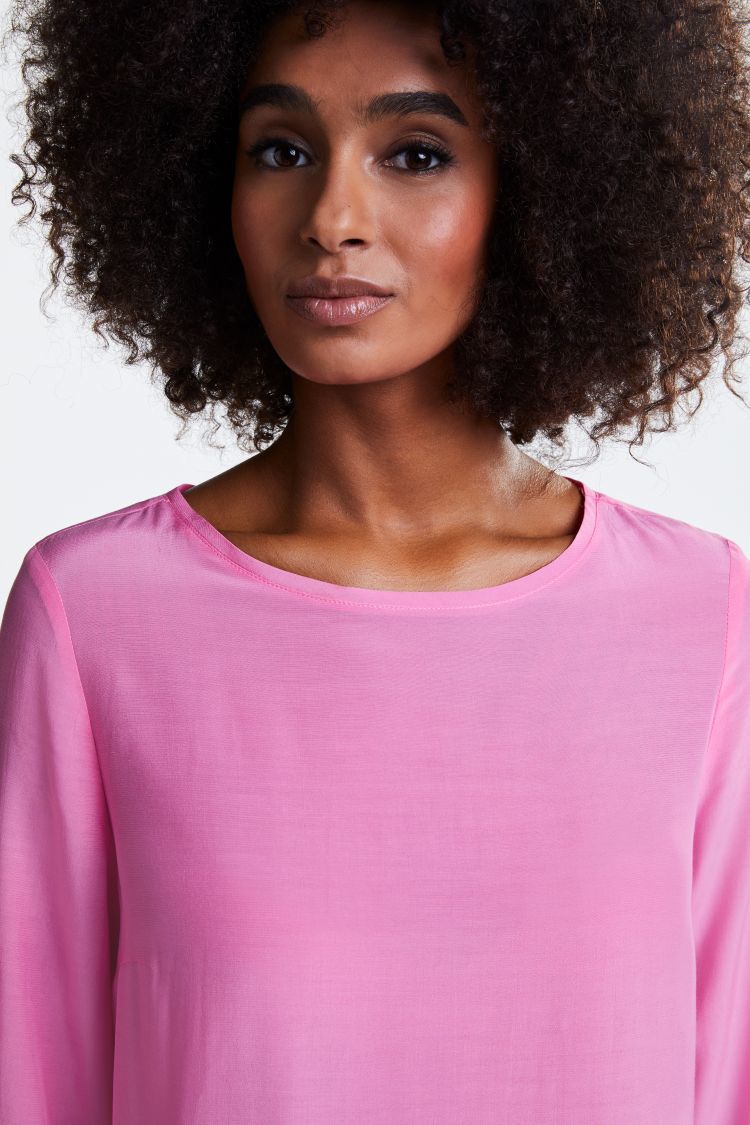 Bright pink top with 3/4 sleeves and dipped hem