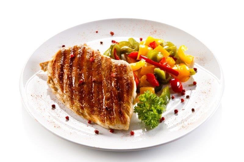 roasted chicken breast served with quinoa and vegetables