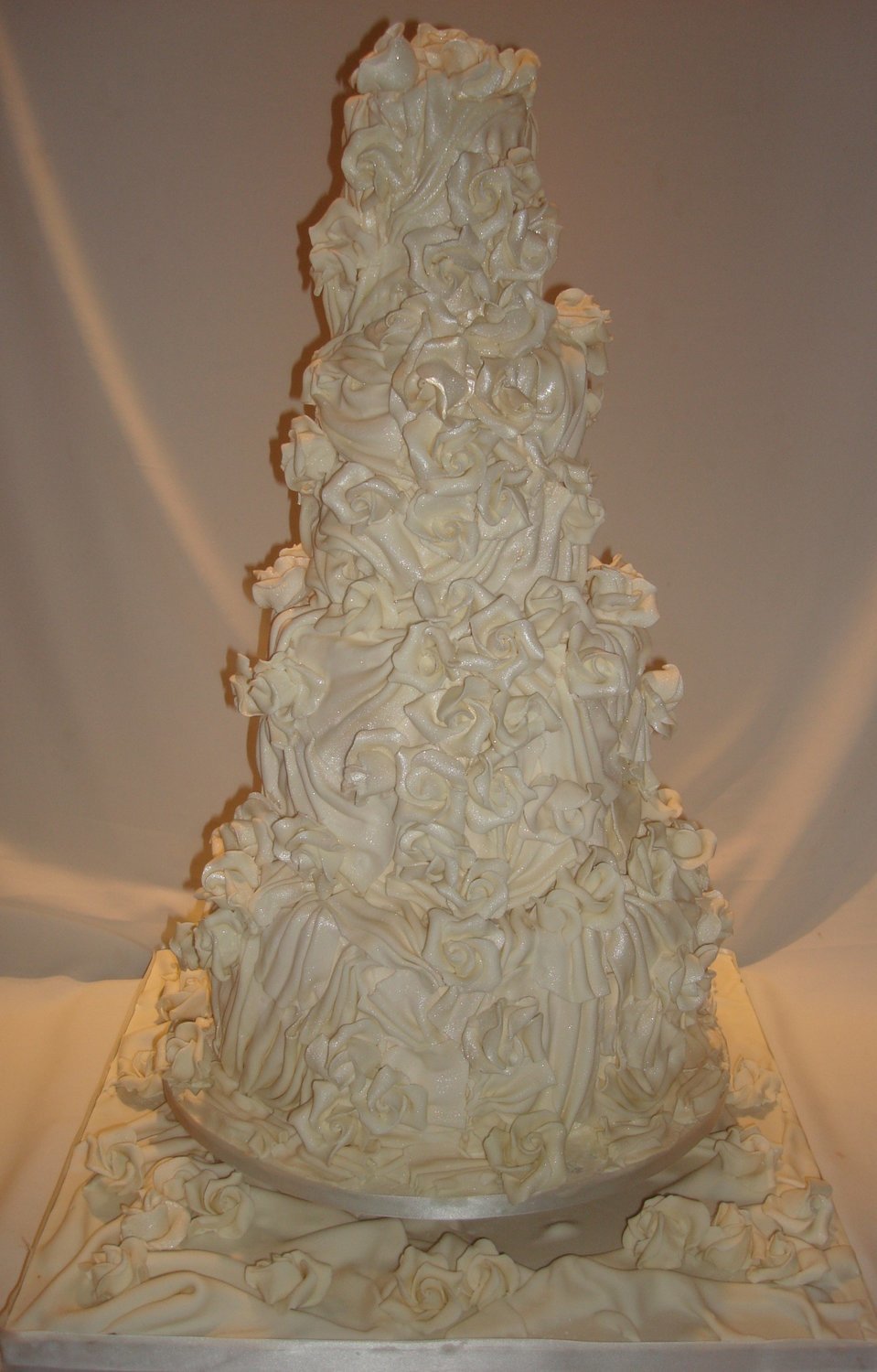 Ivory Drapes And Roses Wedding Cake