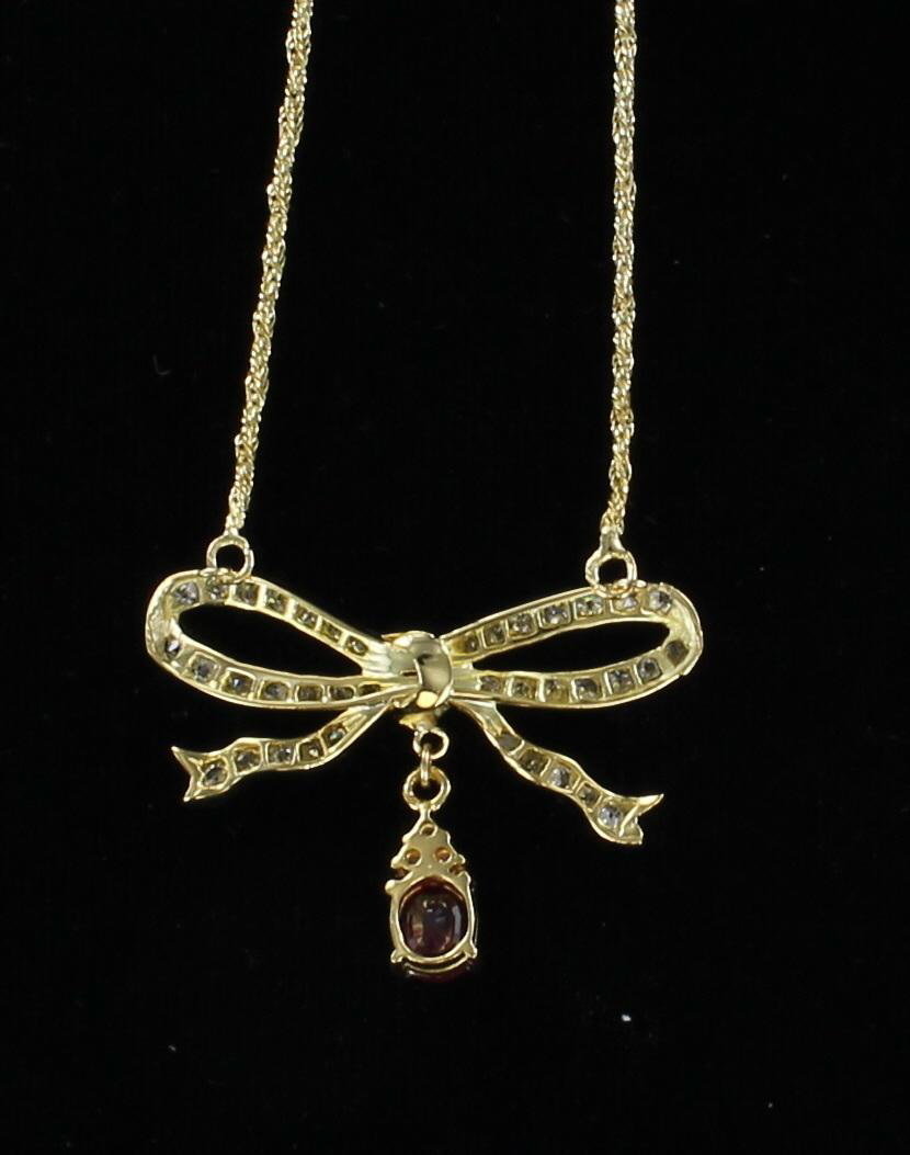 18KT DIAMOND AND RUBY BOW NECKLACE