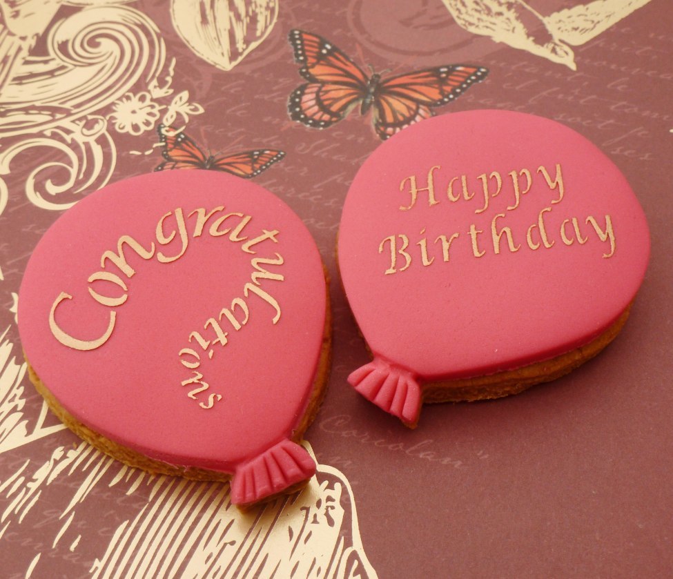 'Congratulations' and 'Happy Birthday' pink balloon cookies, simply decorated using stencils