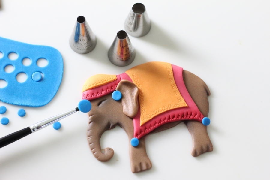 Adding the decoration to the colourful Asian elephant