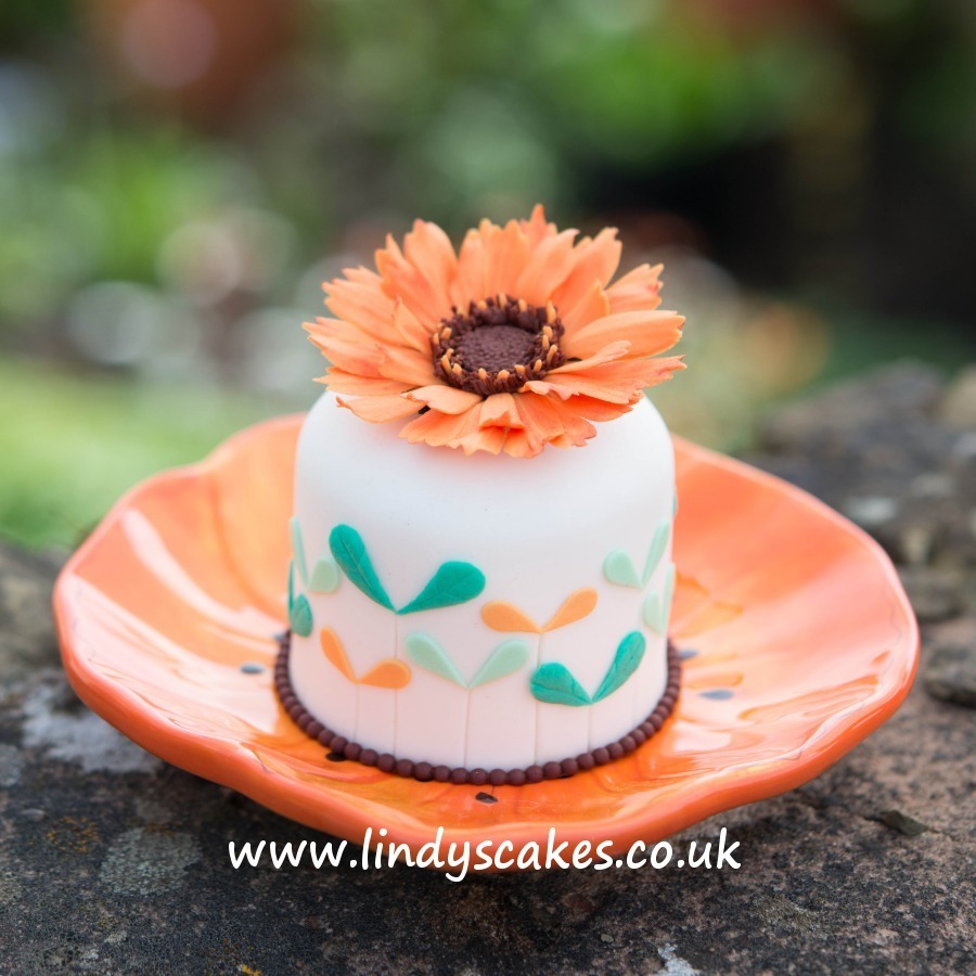 sugar marigold flower tops a mini cake beuatifully