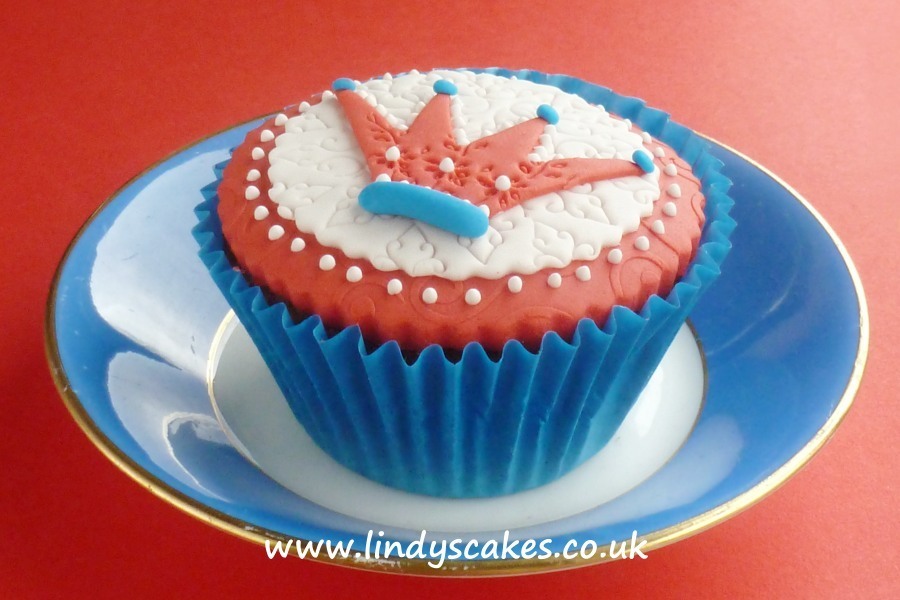 A patriotic cupcake in red white and blue. the sugar crown detail is made using Lindy's sugarcraft crown cutter