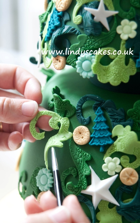 Lace embossers used to create textured detail on this Christmas tree cake from Lindy Smith 'creative colour for cake decorating' book