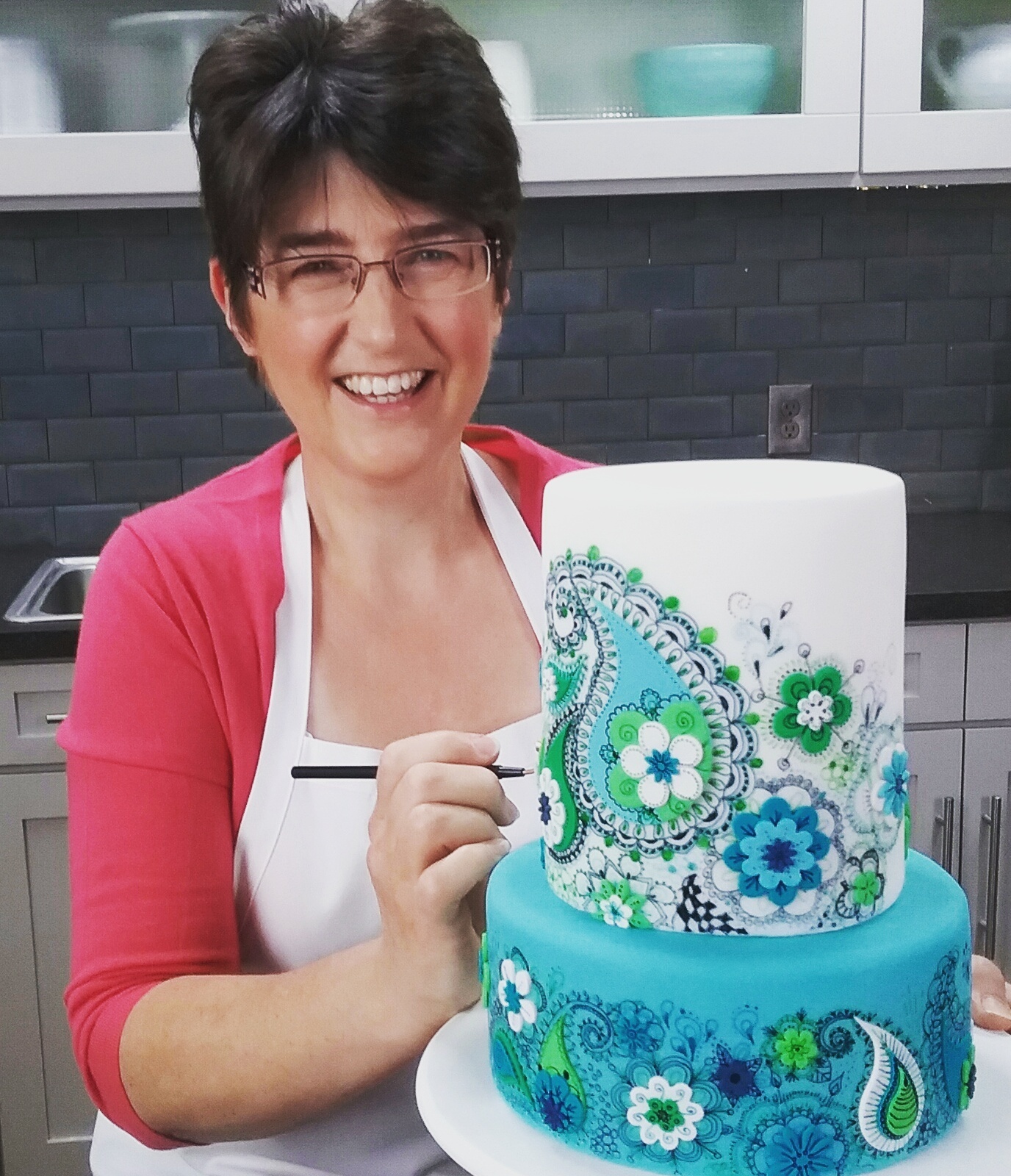 Lindy Smith with her blue and green paisley cake