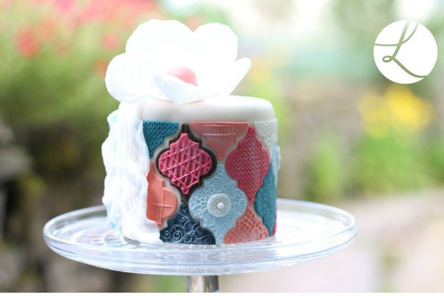 Interlocking Arabesque sugarcraft tile cutter used to decorate this colourful cake