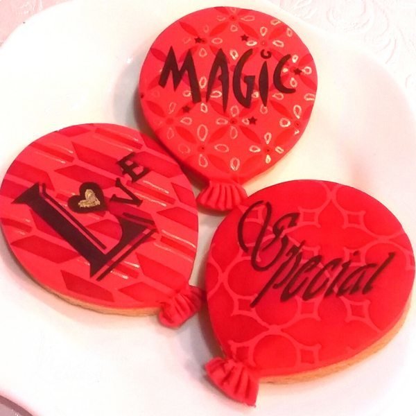 Balloon cookies - one decorated with the retro arrow cake stencil cm004