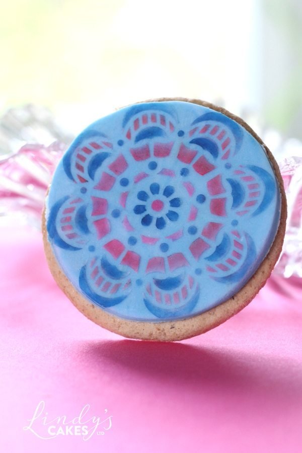 mandal stencil decorating a cookie