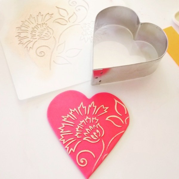 Brushstroke Thistle Flower Cake Stencil used to create a pretty red sugar heart
